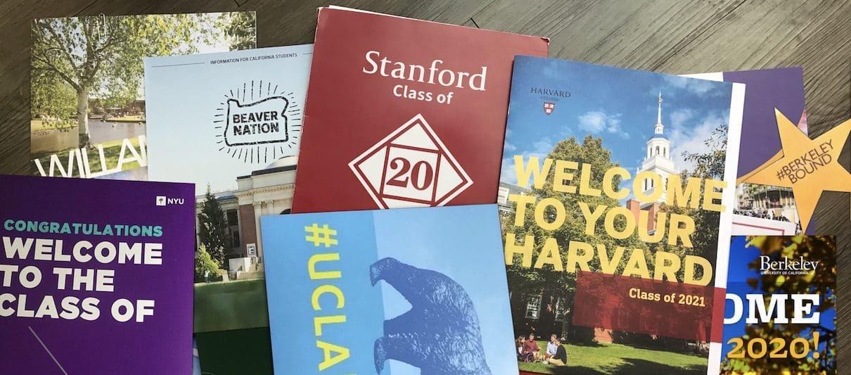 Coveted college acceptance packets on a table, inspiring students to aim higher and never settle