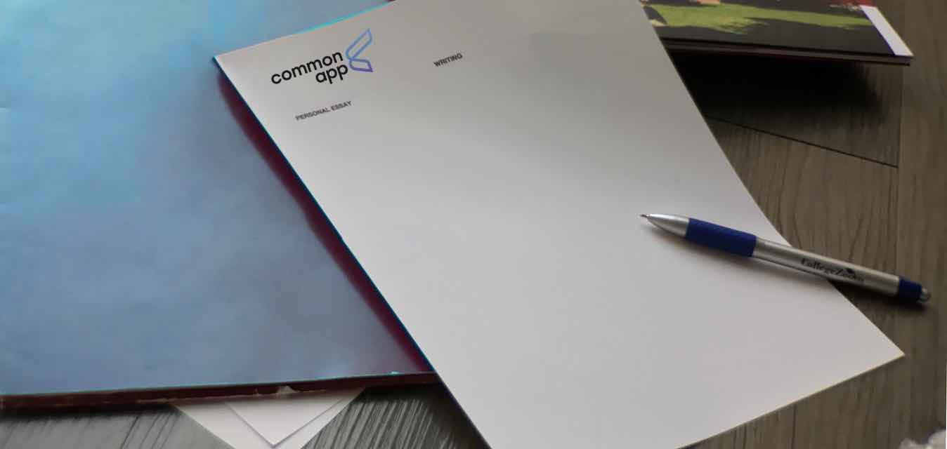College application page surrounded by folders and pen, representing full college app assistance beyond college essays